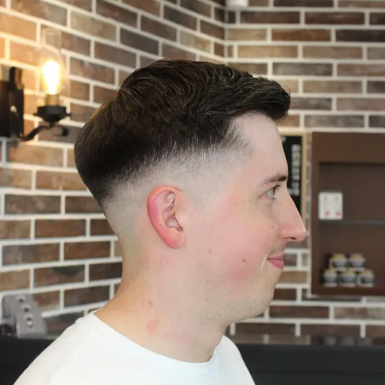 A textured pompadour over a skin fade