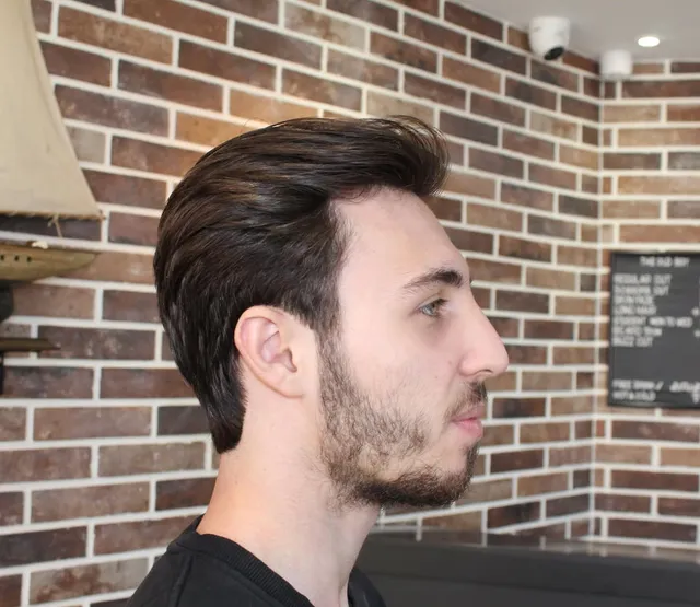 Slicked-back longer cut with a tidy beard